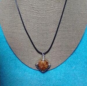 Goldtone brown orange faux amber on black cord necklace